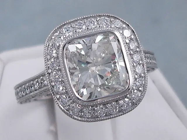 Engagement ring featuring a cushion cut diamond and multiple smaller diamonds