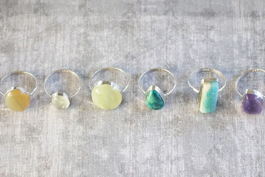 different kinds of gem stone ring aligned in the table